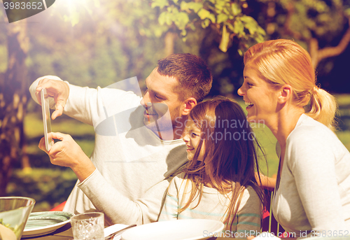 Image of happy family with tablet pc outdoors