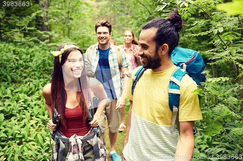 Image of group of smiling friends with backpacks hiking