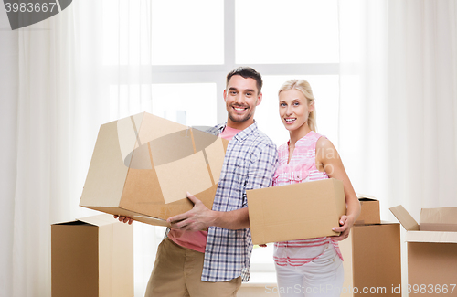 Image of couple with big cardboard boxes moving to new home
