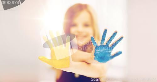 Image of girl showing painted hands