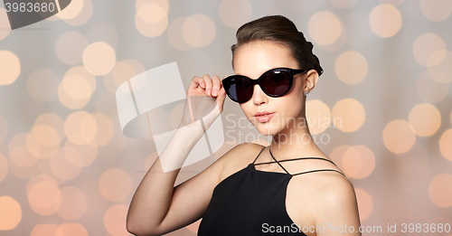 Image of beautiful young woman in elegant black sunglasses