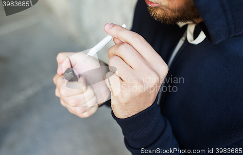 Image of close up of addict smoking marijuana joint