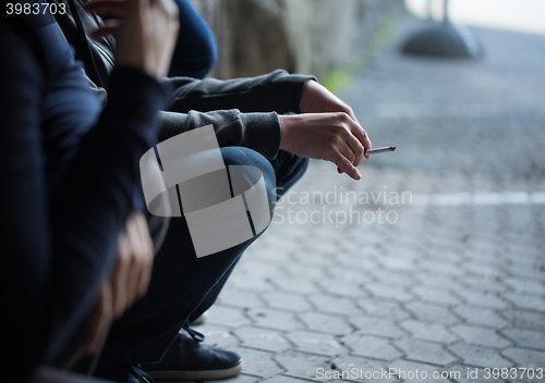 Image of close up of young men smoking cigarettes