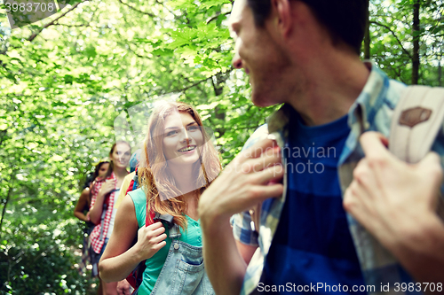 Image of group of smiling friends with backpacks hiking