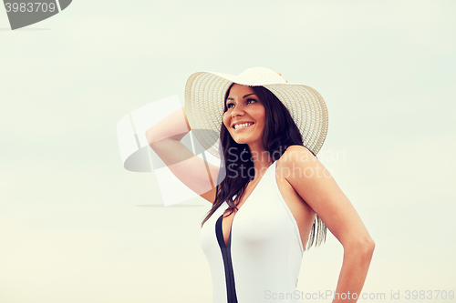 Image of happy young woman on beach