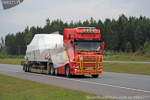 Image of Colorful Scania R560 Hauls Boat along Motorway