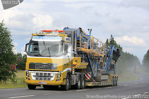 Image of Volvo FH Transports Construction Machinery along Highway