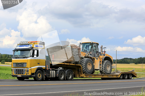 Image of Volvo FH16 and Cat Wheel Loader on Lowboy Traiiler