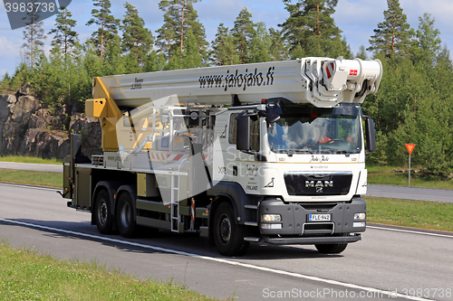 Image of White MAN TGS Boom Truck on the Road