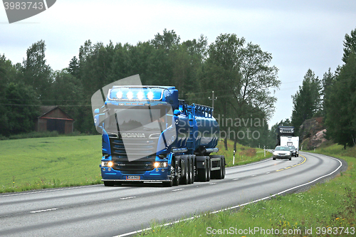 Image of Blue Scania R580 High Beam Lights on the Road