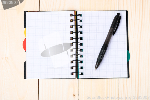 Image of notepad with pen isolated