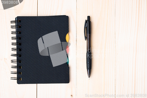 Image of notepad with pen isolated