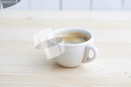 Image of Cup of coffee on wooden table