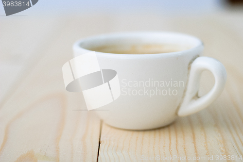 Image of Cup of coffee on wooden table