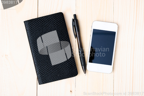 Image of Small notepad with pen and smartphone