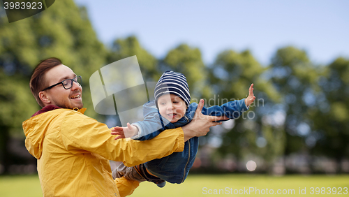 Image of father with son playing and having fun outdoors
