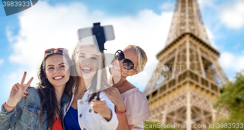 Image of group of smiling women taking selfie in paris