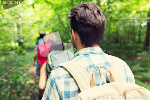 Image of close up of friends with backpacks hiking