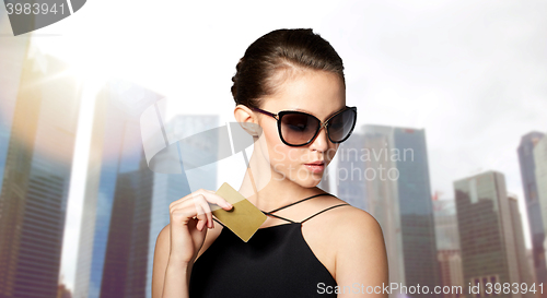 Image of beautiful young woman in elegant black sunglasses