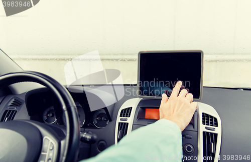 Image of close up of young man with tablet pc driving car