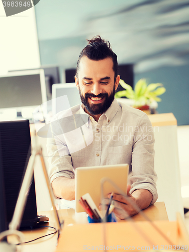 Image of happy creative male office worker with tablet pc