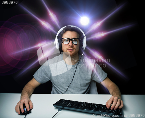 Image of man in headset playing computer video game