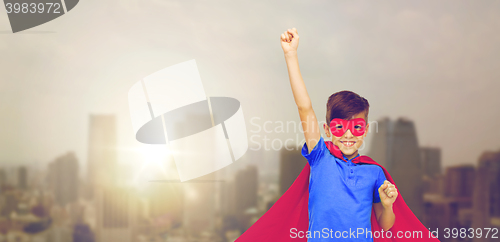 Image of boy in red superhero cape and mask showing fists