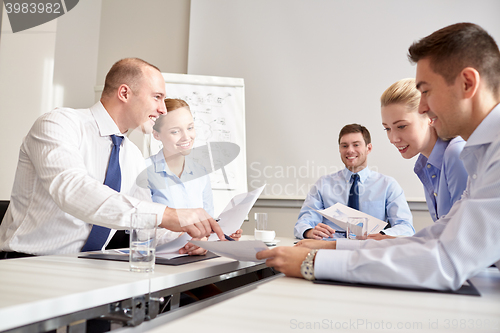 Image of group of smiling businesspeople meeting in office
