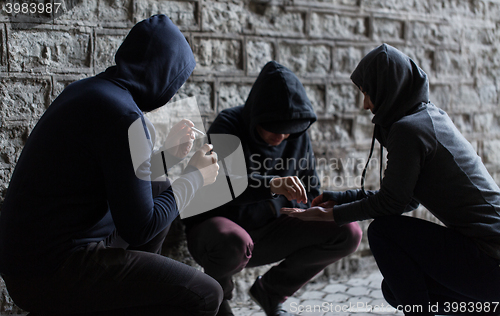 Image of close up of people smoking cigarettes with drugs