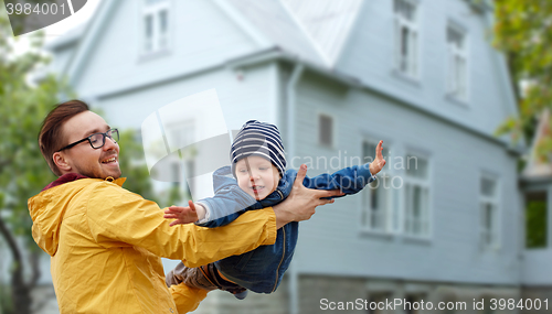 Image of father with son playing and having fun outdoors