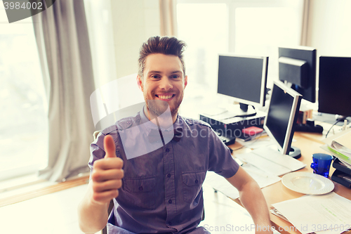 Image of happy male office worker showing thumbs up