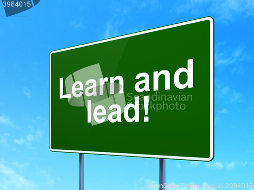 Image of Learning concept: Learn and Lead! on road sign background