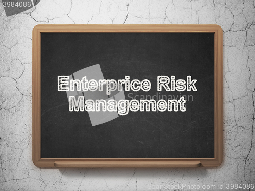 Image of Finance concept: Enterprice Risk Management on chalkboard background