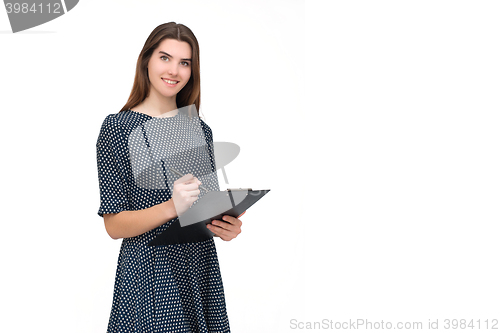 Image of Portrait of smiling business woman with pen and paper folder