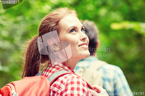 Image of group of smiling friends with backpacks hiking