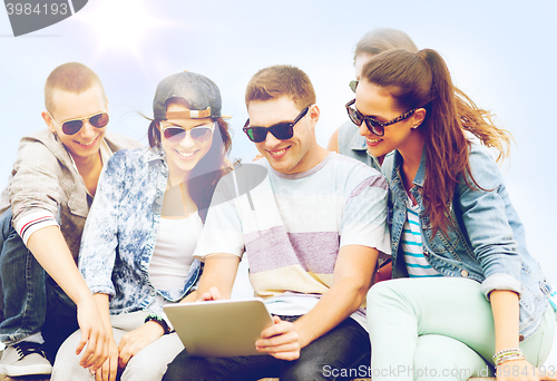 Image of group of teenagers looking at tablet pc