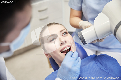 Image of female patient face with x-ray machine and shield