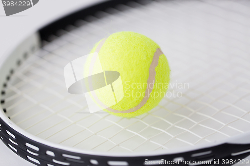 Image of close up of tennis racket with balls