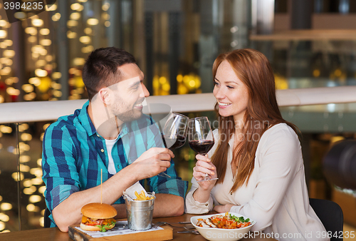 Image of happy couple dining and drink wine at restaurant