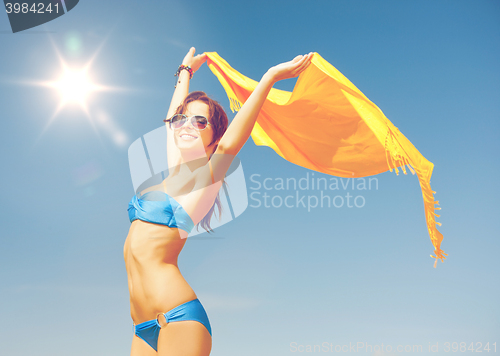 Image of woman in bikini and sunglasses