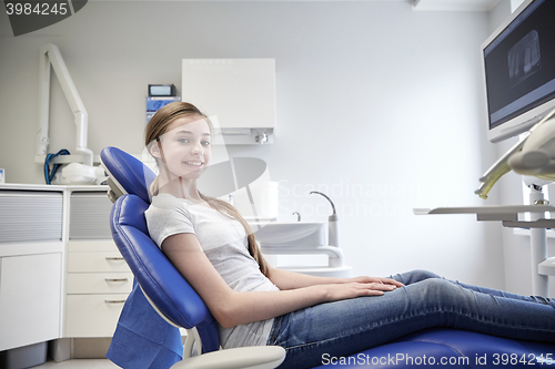 Image of happy patient girl at dental clinic office