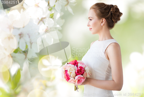 Image of bride or woman in white dress with flower bunch