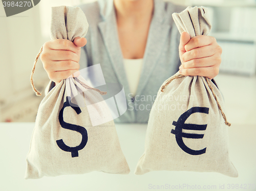 Image of close up of woman hands holding money bags