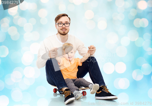 Image of happy father and little son on skateboard