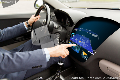 Image of close up of man driving car with gps navigator map