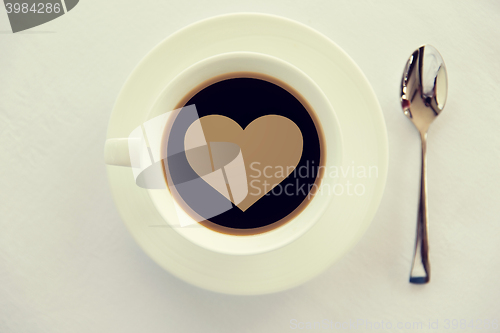 Image of cup of black coffee with heart shape and spoon