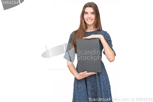 Image of Young smiling woman show blank card or paper