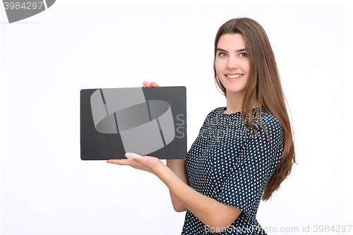 Image of Young smiling woman show blank card or paper