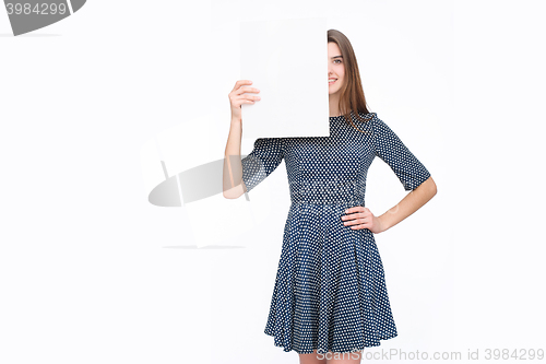 Image of Young smiling woman show blank card or paper