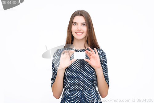 Image of Portrait of young smiling business woman holding blank card